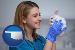 oklahoma map icon and young female vet caring for a bunny