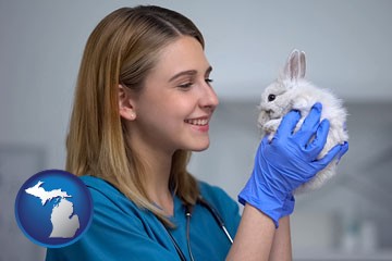 young female vet caring for a bunny - with Michigan icon