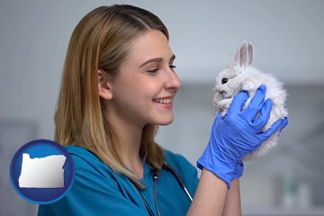 young female vet caring for a bunny - with Oregon icon