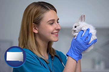 young female vet caring for a bunny - with South Dakota icon